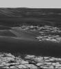 This image, taken Oct. 9, 2005 by NASA's rover Opportunity, is a portion of a mosaic that highlights the light-toned outcrop on the rim of 'Erebus Crater' and large, dark, wind-deposited drifts that have filled the center of the crater.