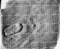 This is an oblique view of the crater complex near Ascraeus Lacus in the Tharsis region of Mars was taken by NASA's Mariner 9 in 1971. The spot consists of several intersecting shallow crater-like depressions.