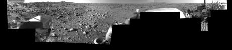 This image was taken by NASA's Viking Lander 1 at Chryse Planitia on Mars. The lander can be seen in the foreground looking toward the rugged martian terrain.
