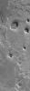 NASA's Mars Global Surveyor shows two small mesas, a hill, and other landforms in the highly-eroded landscape of eastern Arabia Terra on Mars.
