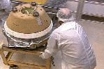 This frame from a movie from NASA's Stardust shows rehearsal of the initial processing of the sample return capsule when it is taken to a temporary cleanroom at Utah's Test and Training Range.