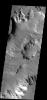 This image shows part of Shalbatana Vallis on Mars, with steep cliffsides and large pit in the channel floor. Many small channels appear to end at the pit, or pass to its north as seen by NASA's 2001 Mars Odyssey spacecraft.