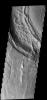 This image from NASA's 2001 Mars Odyssey spacecraft shows part of the caldera rim of Nili Patera on Mars. Dunes are located within the caldera.