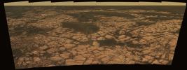 This view from the NASA's Mars Exploration Rover Opportunity shows an outcrop called 'Olympia' along the northwestern margin of 'Erebus' crater. A dry cracked surface a broad expanse of sulfate-rich sedimentary rocks.
