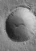 NASA's Mars Global Surveyor shows an impact crater with large boulders along its rim. The crater is located in Tempe Terra on Mars.