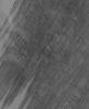 NASA's Mars Global Surveyor shows a wind-streaked plain in Tharsis near the Pavonis Mons volcano on Mars. The lighter-toned surfaces show how the plain used to look, before strong winds removed much of a thin coating of dust.