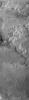In this image from NASA's Mars Odyssey spacecraftwestern flows change in appearance. The flows are typically broad, and the surface texture is more subdued than the southern flows. At the bottom of the image a windstreak 'tail' has formed behind a crater.