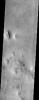 An isolated mesa east of the Phlegra Montes in northeastern Elysium Planitia has a cracked surface that, combined with its overall shape, gives the appearance of a giant loaf of bread in this image from NASA's Mars Odyssey spacecraft.