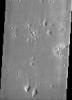 Impact craters in Hecates Tholus, as seen in this image from NASA's Mars Odyssey spacecraft, appear to be filled with sediment derived from erosion of the surrounding terrain.