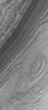 NASA's Mars Global Surveyor shows layered material exposed by erosion in the south polar region of Mars. At the time the image was acquired, the surface was covered with seasonal carbon dioxide frost.
