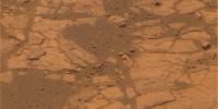 After months spent crossing a sea of rippled sands, NASA's Opportunity rover reached an outcrop in August 2005 and began investigating exposures of sedimentary rocks, intriguing rind-like features that appear to cap the rocks.