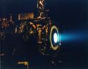 This image of a xenon ion engine, photographed through a port of the vacuum chamber where it was being tested at NASA's Jet Propulsion Laboratory, shows the faint blue glow of charged atoms being emitted from the engine.