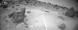 NASA's Sojourner takes a picture of one of its hazard-detecting laser stripes which is clearly visible against the Martian surface. Sol 1 began on July 4, 1997.