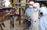 JPL engineers examine the robotic arm of NASA's Mars Exploration Rover 1.