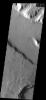This image from NASA's Mars Odyssey shows lines indicative of flow in a valley floor on Mars cut across similar lines in a slightly smaller valley, indicating both that material flowed along the valley floor.
