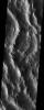 This image taken by NASA's 2001 Mars Odyssey shows rugged terrain that is part of a massive lobe of material extending from the basal scarp of Mars' Olympus Mons is called sulci, which means furrows or grooves.