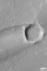 NASA's Mars Global Surveyor shows a streak formed by wind in the lee of a meteor impact crater on Mars.