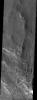 NASA's Mars Odyssey spacecraft captured this image in August 2003, showing an unusual layer of smooth material covering the flanks of the volcano Peneus Patera just south of the Hellas Basin on Mars.