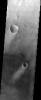 NASA's Mars Odyssey spacecraft captured this image in September 2003, showing bright wind streaks in the lee of craters and other obstacles in this image, located in Sinus Sabaeus, near the Martian equator.