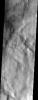 Volatile rich material of Terra Sirenum. This material appears pasted on in places as well as pitted. The volatile rich material may be dirty snow. This image was captured by NASA's Mars Odyssey spacecraft in September 2003.