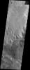 Layered material can be seen eroding out of Ritchey crater. Some small channels are also visible on the deposit. This image was captured by NASA's Mars Odyssey spacecraft in October 2003.