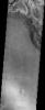 A stack of eroding sediments roughly 200 meters high contains the northeastern-most occurrence of the hematite layer that covers much of Meridiani Planum in this image taken in October 2003 by NASA's Mars Odyssey spacecraft.