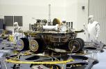 In the Payload Hazardous Servicing Facility, the lander petals of the Mars Exploration Rover 2 (MER-2) have been reopened and its solar panels deployed to allow technicians access to the spacecraft to remove one of its circuit boards. 
