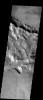 The rims of two old and degraded impact craters are intersected by a graben near Mangala Fossa. This image was captured by NASA's Mars Odyssey spacecraft in November 2003.