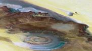 This prominent circular feature, known as the Richat Structure, in the Sahara desert of Mauritania is often noted by astronauts because it forms a conspicuous bull's-eye on the otherwise rather featureless expanse of the desert.