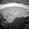 NASA's Mars Exploration Rover Spirit looks back at the circular tracks made in the martian soil when it drove toward the mountain-shaped rock called Adirondack, Spirit's first rock target. Two rocks called 'Sashimi' and 'Sushi' are seen in the distance.