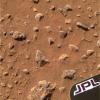 NASA's Mars Exploration Rover Spirit shows the region containing the patch of soil scientists examined at Gusev Crater just after Spirit rolled off the Columbia Memorial Station. Rocks are strewn on Mars' red surface.