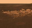 NASA's Mars Exploration Rover Opportunity highlights a portion of a puzzling reddish hue rock outcropping thought to be either volcanic ash deposits or sediments carried by water or wind.