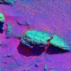 This false-color image (purple surface and blue rock) taken by NASA's Mars Exploration Rover Opportunity highlights the spherules, or tiny spheres, that speckle the rock dubbed Stone Mountain.