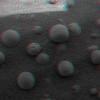 This is 3-D anaglyph, from NASA's Mars Exploration Rover Spirit, shows an extreme close-up of round, blueberry-shaped grains on the crater floor near the rock outcrop at Meridiani Planum called Stone Mountain. 3D glasses are necessary.
