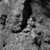 NASA's Mars Exploration Rover Opportunity 's instrument deployment device, or 'arm,' shows partial 'clodding' or cementation of the sand-sized grains within twall trenched by the rover.