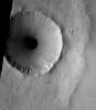 This image, part of an images as art series from NASA's 2001 Mars Odyssey released on Feb 4, 2004 shows an eye-like crater-in-a-crater on Mars and see Mars looking back at you.