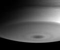 This view of Saturn's south pole shows a prominent dark spot, along with flowing, wave-like patterns to the north and toward the right. This image from NASA's Cassini spacecraft was taken on July 13, 2004.