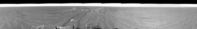This image is a 360-degree view from NASA's Mars Exploration Rover Opportunity's position outside the small crater 'Eagle Crater.' Plentiful ripples are seen on the plains and two depressions featuring bright spots.