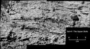 This magnified view from NASA's Mars Exploration Rover Opportunity of a portion of a martian rock called 'Upper Dells' shows fine layers (laminae) that are truncated, discordant and at angles to each other. Eight spherules are embedded in the rock.
