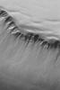 NASA's Mars Global Surveyor shows gullies and slopes in the walls of a deep pit in the south polar region of Mars.