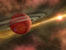 In this artist's conception, a possible newfound planet spins through a clearing in a nearby star's dusty, planet-forming disc. This clearing was detected around the star CoKu Tau 4 by NASA's Spitzer Space Telescope. 