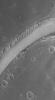 NASA's Mars Global Surveyor shows a ripple-covered valley floor in the Hyblaeus Fossae region on Mars. Winds blowing up and down the length of the valley have helped to concentrate windblown grains to form these large, megaripples.