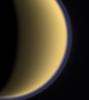 Encircled in purple stratospheric haze, Titan appears as a softly glowing sphere in this colorized image taken one day after NASA's Cassini spacecraft first flyby of the moon on July 2, 2004.