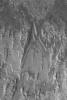 NASA's Mars Global Surveyor shows eroded layer outcrops in a crater in Terra Tyrrhena on Mars where exposures of layered, sedimentary rock are common.