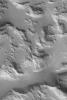 NASA's Mars Global Surveyor shows rugged hills and mountains mantled by a blanket of fine dust in Sulci Gordii on Mars. Ripple-like dunes in the troughs between each hill or mountain have also been covered with dust.