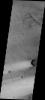 This image released on July 12, 2004 from NASA's 2001 Mars Odyssey shows windstreaks are features caused by the interaction of wind and topographic landforms such as raised rims and bowls of impact craters on Mars.