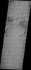 This image released on July 14, 2004 from NASA's 2001 Mars Odyssey shows windstreaks are features caused by the interaction of wind and topographic landforms such as sand dunes with multiple linear ridges. These ridges are yardangs.