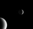 This captivating portrait captures Saturn's wispy moon Dione over the shoulder of smoggy Titan in a single inspiring scene taken by NASA's Cassini spacecraft on Feb. 18, 2005.