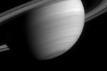 This poetic wide-angle camera view of Saturn reveals several small, dark storms in the southern latitudes, where storm activity has been prevalent since before NASA's Cassini spacecraft arrived in orbit.