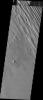 This image released on July 21, 2004 from NASA's 2001 Mars Odyssey shows that eons of atmospheric dust storm activity has left its mark on the surface of Mars such as this classic yardang formed by wind.